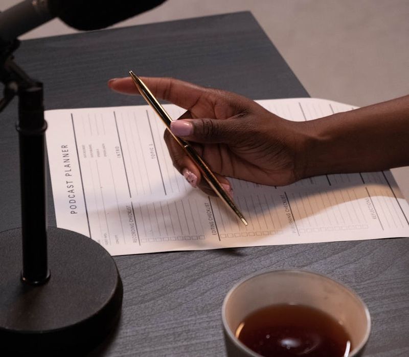 Woman looking at her daily schedule with a cup of tea.